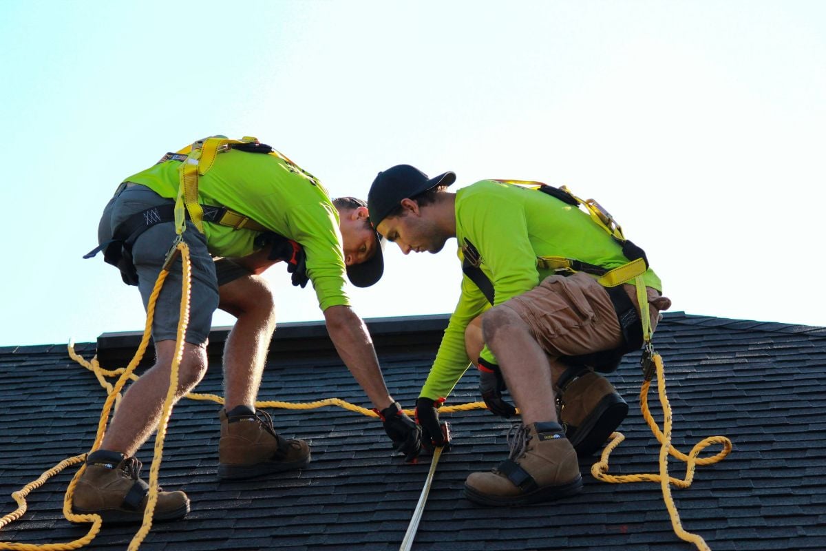 two men working on a roof